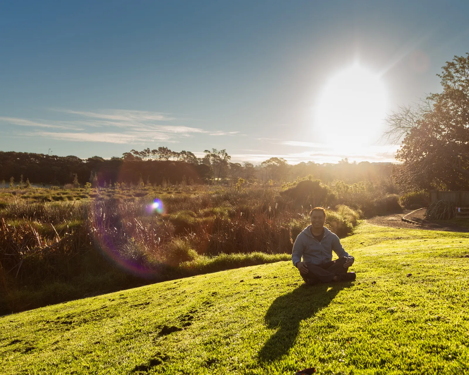 Zhi Lee meditating in Waitarua Reserve